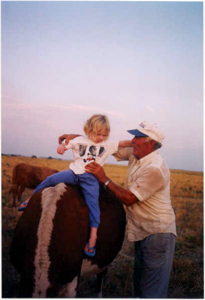 Emma Rues, Buddy the calf and Vic Higgins, practicing for future rodeo participation.