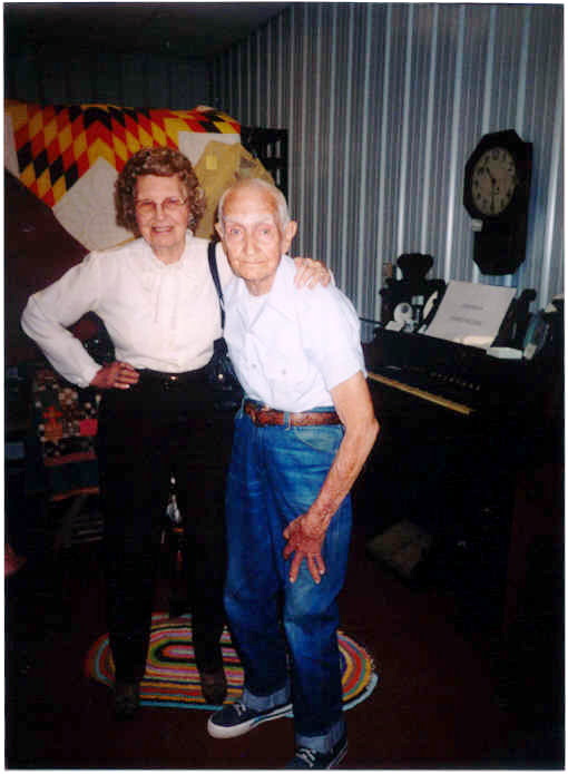 Picture of Willis Redding (Class of 1937), son of Herman Redding, Janitor at McCracken schools, and Doris Doerr (wife of Adrian Doerr (Class of 1939) at Jail/Museum.  Background organ from EUB Church and clock from McCracken Depot.