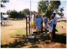Alumni look at new Alumni Memorial plaque at City Park following Memorial Serivce.  Ben Anderson, Maynard Swisher, Gerald Walker, G. T. Barnes and Nancy Anderson.  The plaque stand was constructed and placed by Roy Conrad.