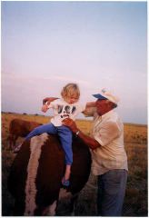 Emma Rues, Buddy the calf and Vic Higgins, practicing for future rodeo participation.