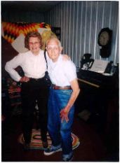 Picture of Willis Redding (Class of 1937), son of Herman Redding, Janitor at McCracken schools, and Doris Doerr (wife of Adrian Doerr (Class of 1939) at Jail/Museum.  Background organ from EUB Church and clock from McCracken Depot.