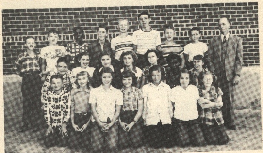 Grade School 1951-1952 Grades 6th, 7th, & 8th 3rd row:  Roy Conrad, Bobby Higgins, Augustine Thompson, Gary Moses, John Hanson, Linus Schlitter, Larry Eisenhour, Bobby Cain, Mr. Alvin Maddy, teacher.

 

2nd row:  Gerald Crotinger, Ona Ruth Dixon, Diana Walker, Jodene Dawson, Pat Ryan, Patricia Thompson, Clara Mae Grumbein.

 

1st row:  Eddie Schuckman, Carol Faye Bible, Verna Mae Dixon, Marjean Jones, Hazel Pfaff, Mary Ann Graf, Reva Rodeman.