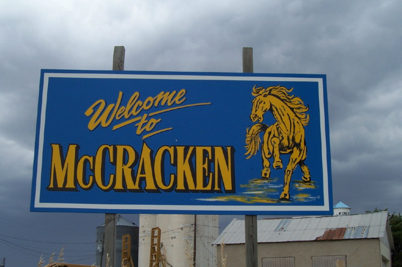Welcome to McCracken signs at the north and south end of McCracken.  They were painted by Kurt Werth, Russell.