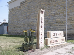 Metal catcus made by Pat Istas in front of the McCracken Jail/Museum