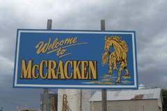 Welcome to McCracken signs at the north and south end of McCracken. They were painted by Kurt Werth, Russell.